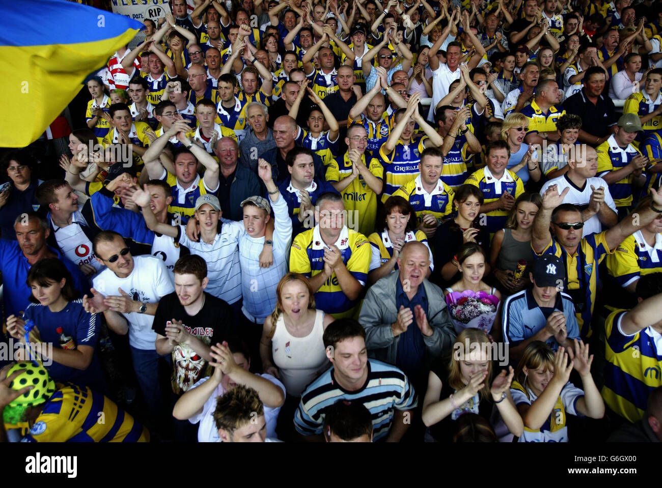 Warrington fans celebrate after their Tetley's Super League match against Wakefield where the final game was played at the Wilderspool ground in Warrington. Stock Photo