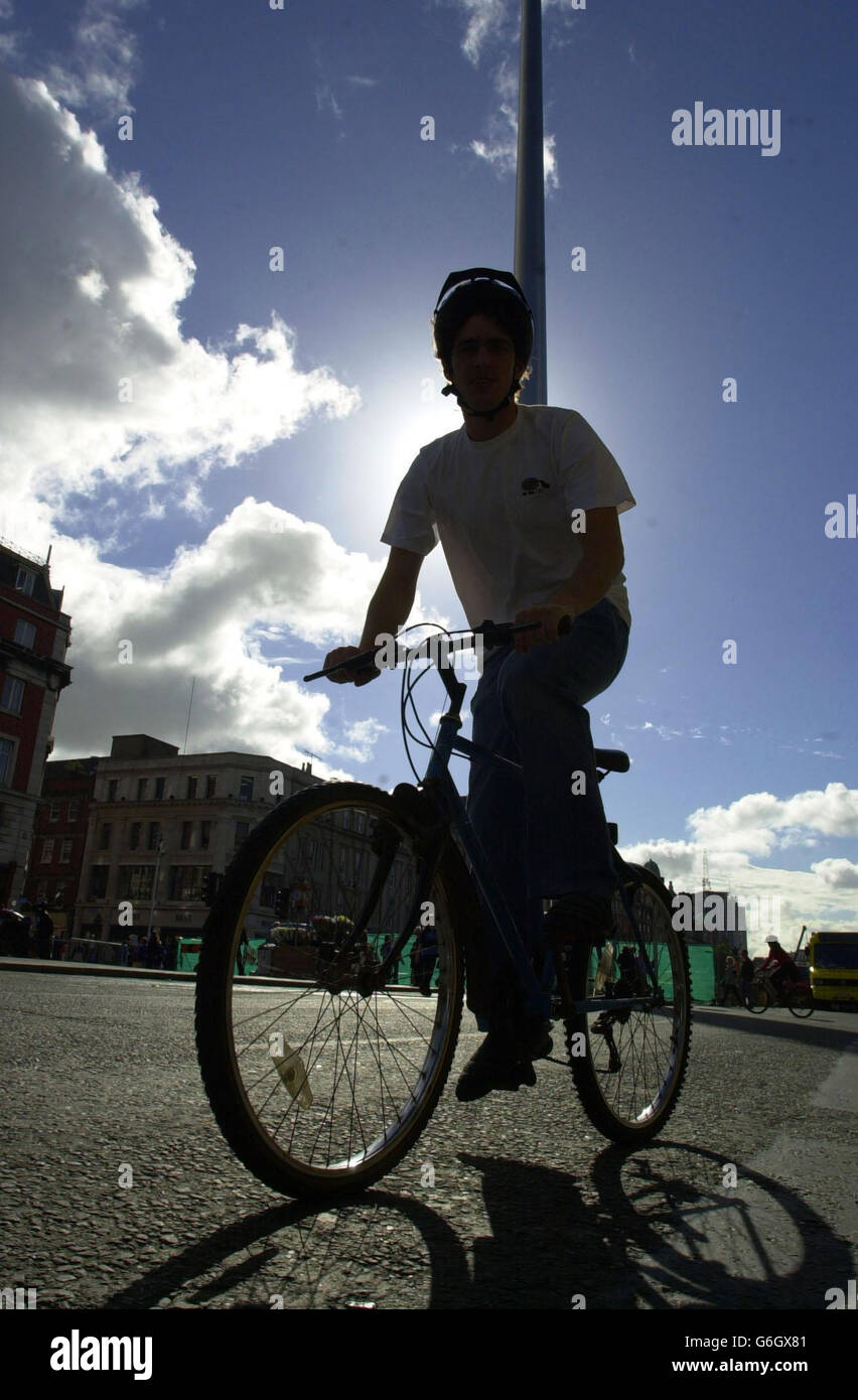 A cyclist rides up O'Connell Street on European Car Free Day, in Dublin, Ireland. Passengers were travelling on the Irish Republic's buses free of charge in a bid to ease traffic congestion in urban centres. * Car-free day was being marked in 17 Irish towns and cities with passengers enjoying free travel between 10am and 4pm. Dublin Bus was offering free use of its services from 10am to 1pm in a bid to show passengers the benefits of leaving their cars at home. Stock Photo