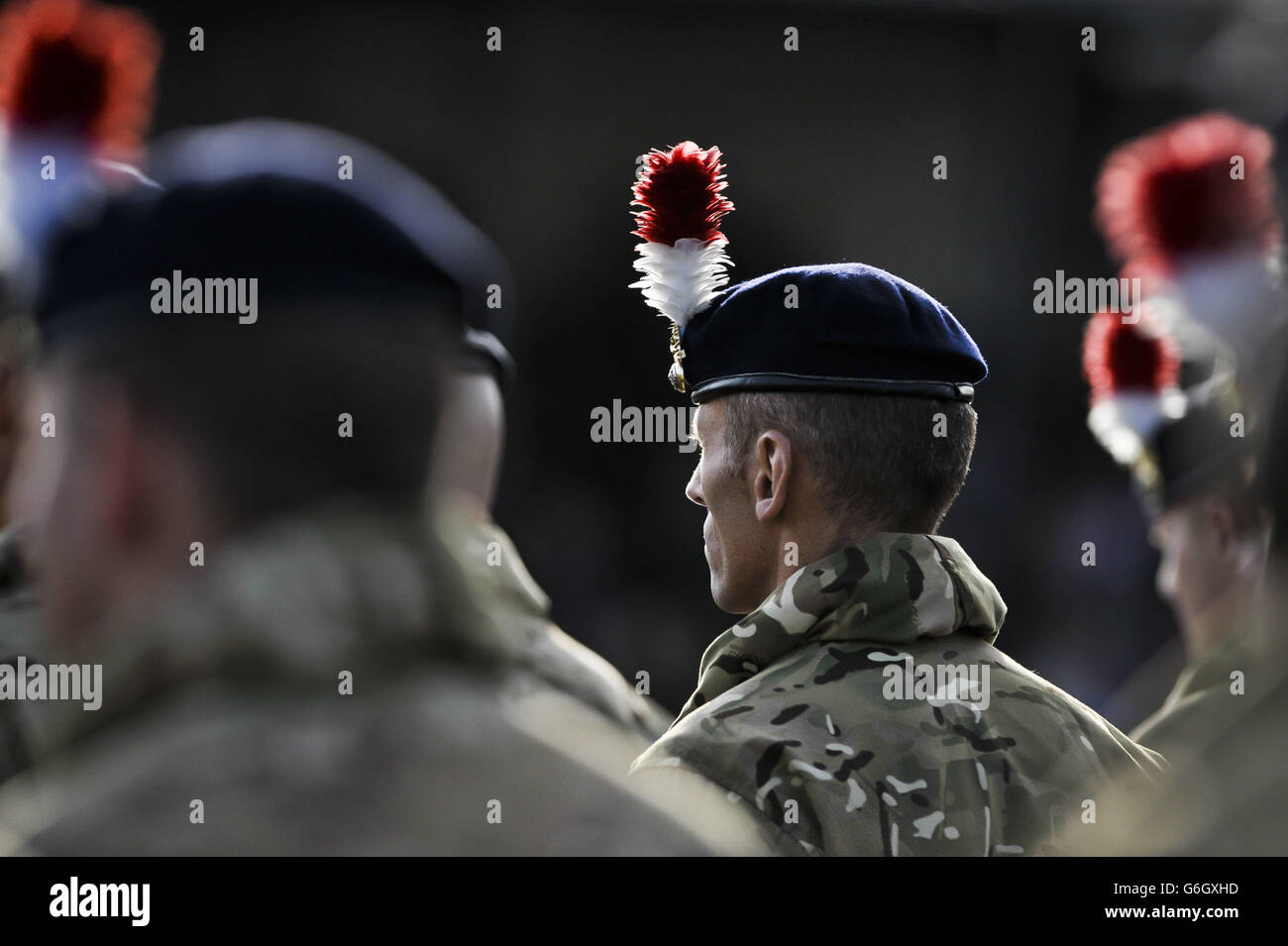 Sunlight highlights the hackles on a soldiers beret from 1st Battalion The  Royal Regiment of Fusiliers as they parade in front of family and friends  and receive their Afghanistan campaign medals for