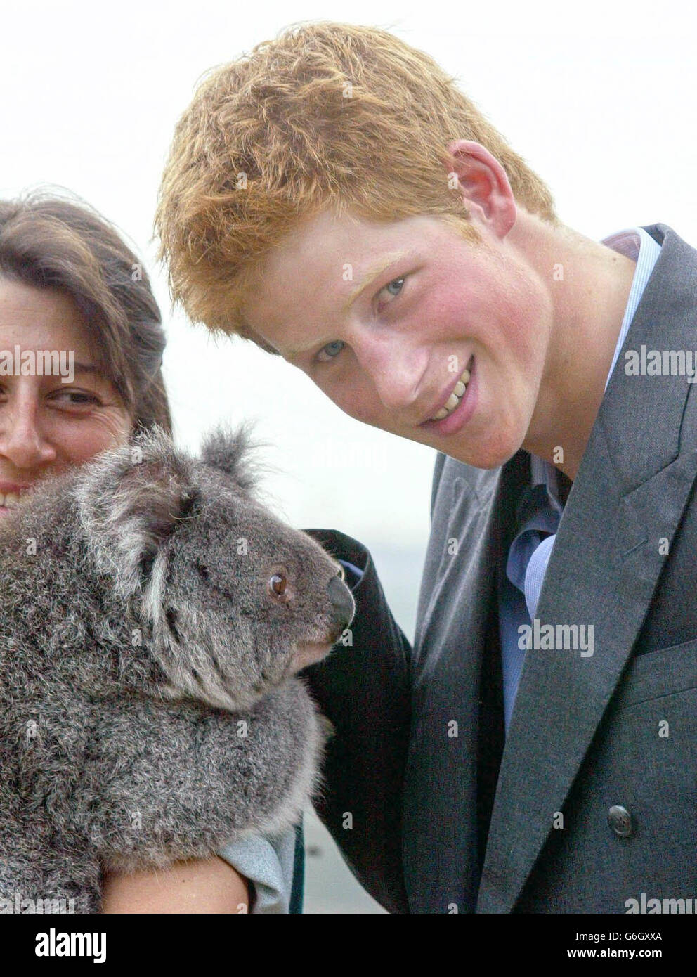 Prince Harry poses with a koala during a photocall at Taronga Zoo in