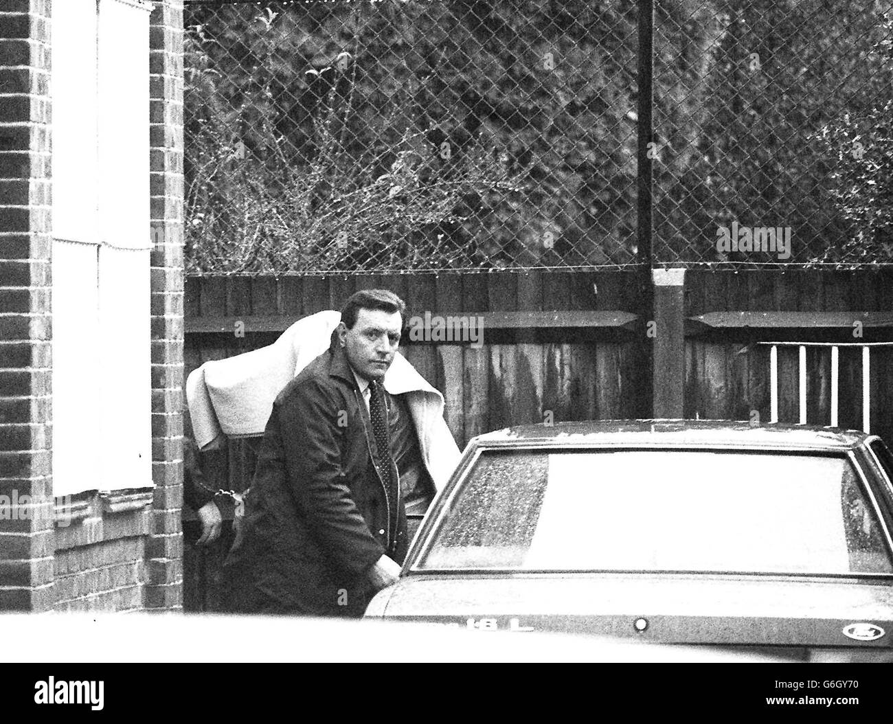 A handcuffed figure, covered with a blanket, at Fleetham Magistrates Court, London. The unidentified figure is presumed to be Brian Robinson. Stock Photo