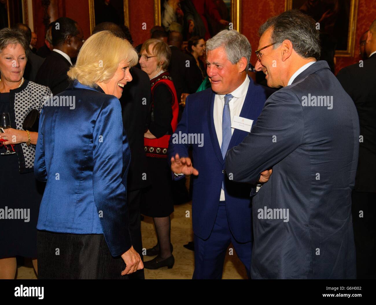 The Duchess of Cornwall speaks to Theatre Producer Cameron Mackintosh (centre) and Michael Degiorgio of the Greenhouse Charity (right) at a reception for Commonwealth nations representatives, at Buckingham Palace, in central London. Stock Photo