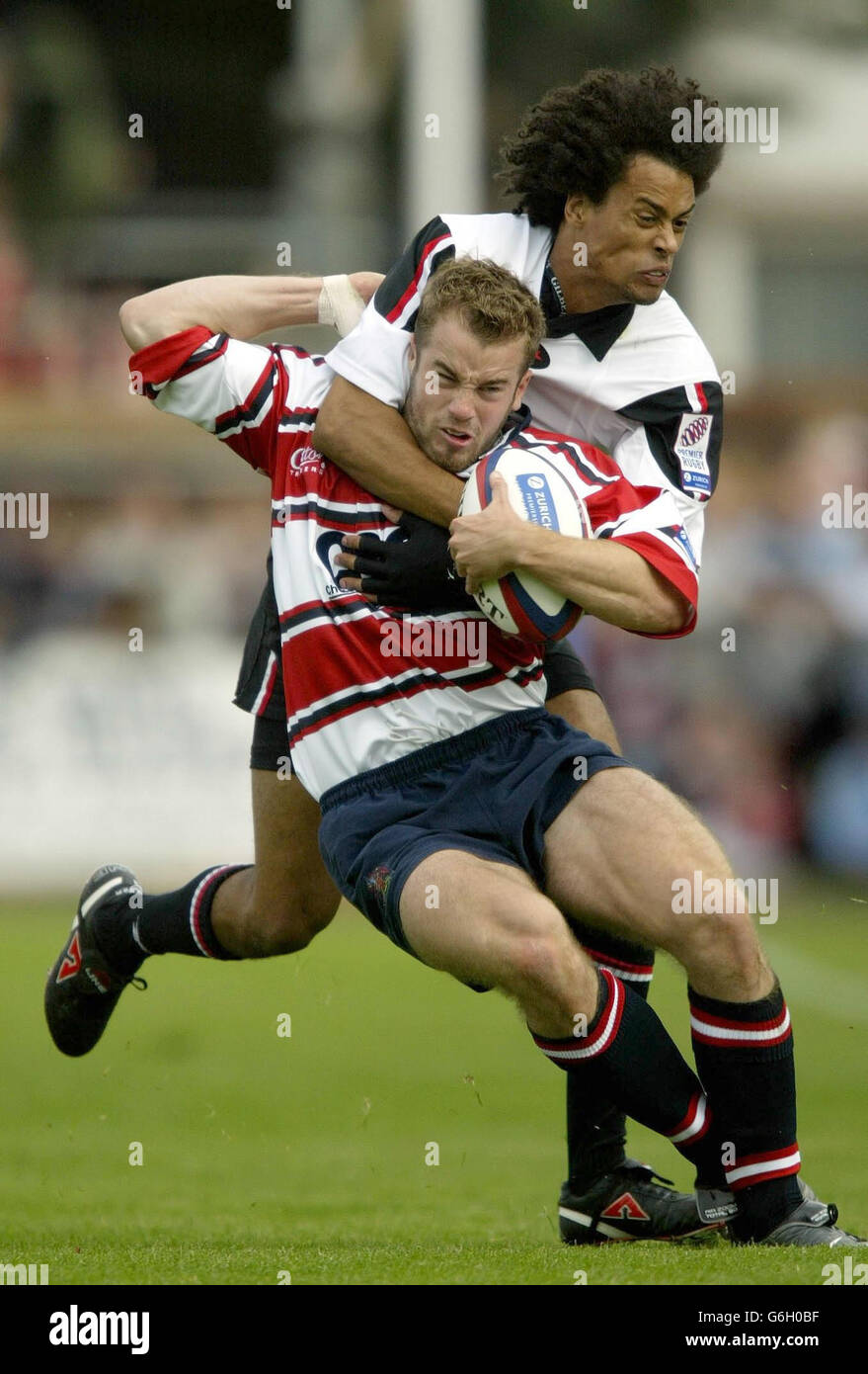 Gloucester's James Simpson-Daniel is caught by Richard Haughton of Saracens during the Zurich Premiership match at Kingsholm, Gloucester. Stock Photo