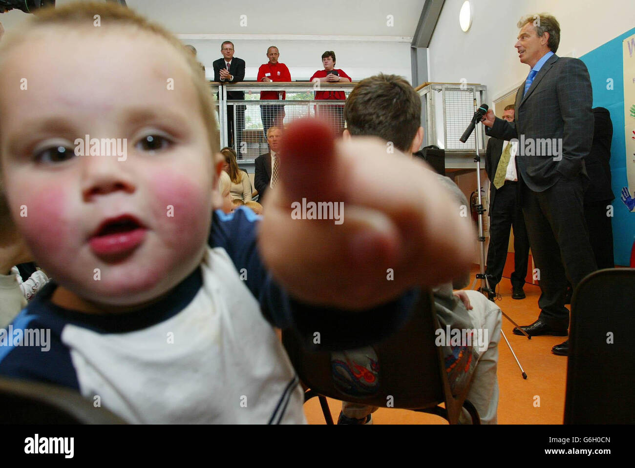 Prime Minister Tony Blair addresses a young audience at an adventure playground during a visit with his deputy John Prescott to the Sure Start centre in Weston, Southampton. Stock Photo