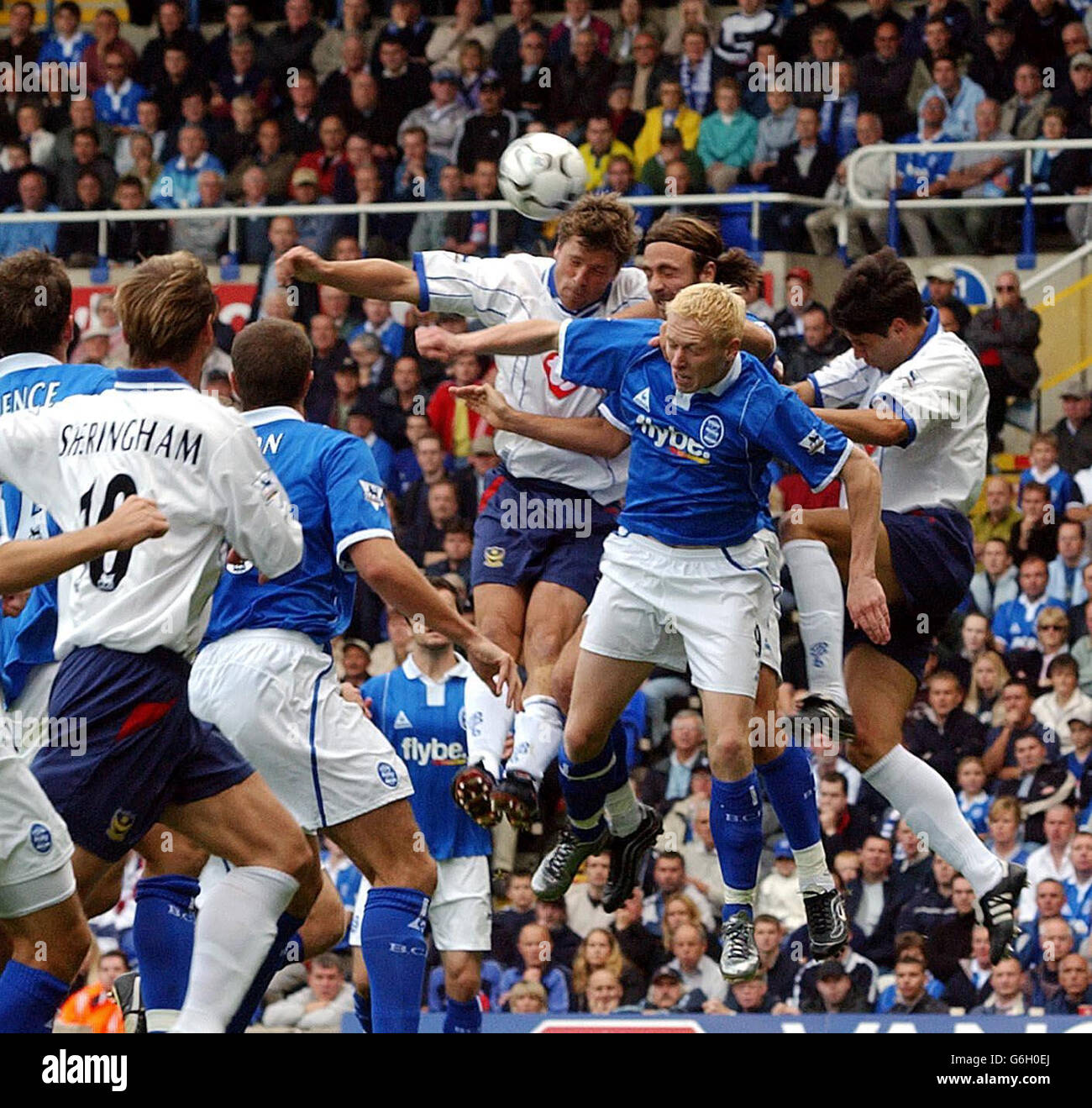 Portsmouth's Arjan De Zeeuw climbs highest to win a header from Birmingham City strikers Mikael Forssell (blonde) and Christophe Dugarry (behind Forssell) during their FA Barclaycard Premiership match at St Andrews, Birmingham. Stock Photo