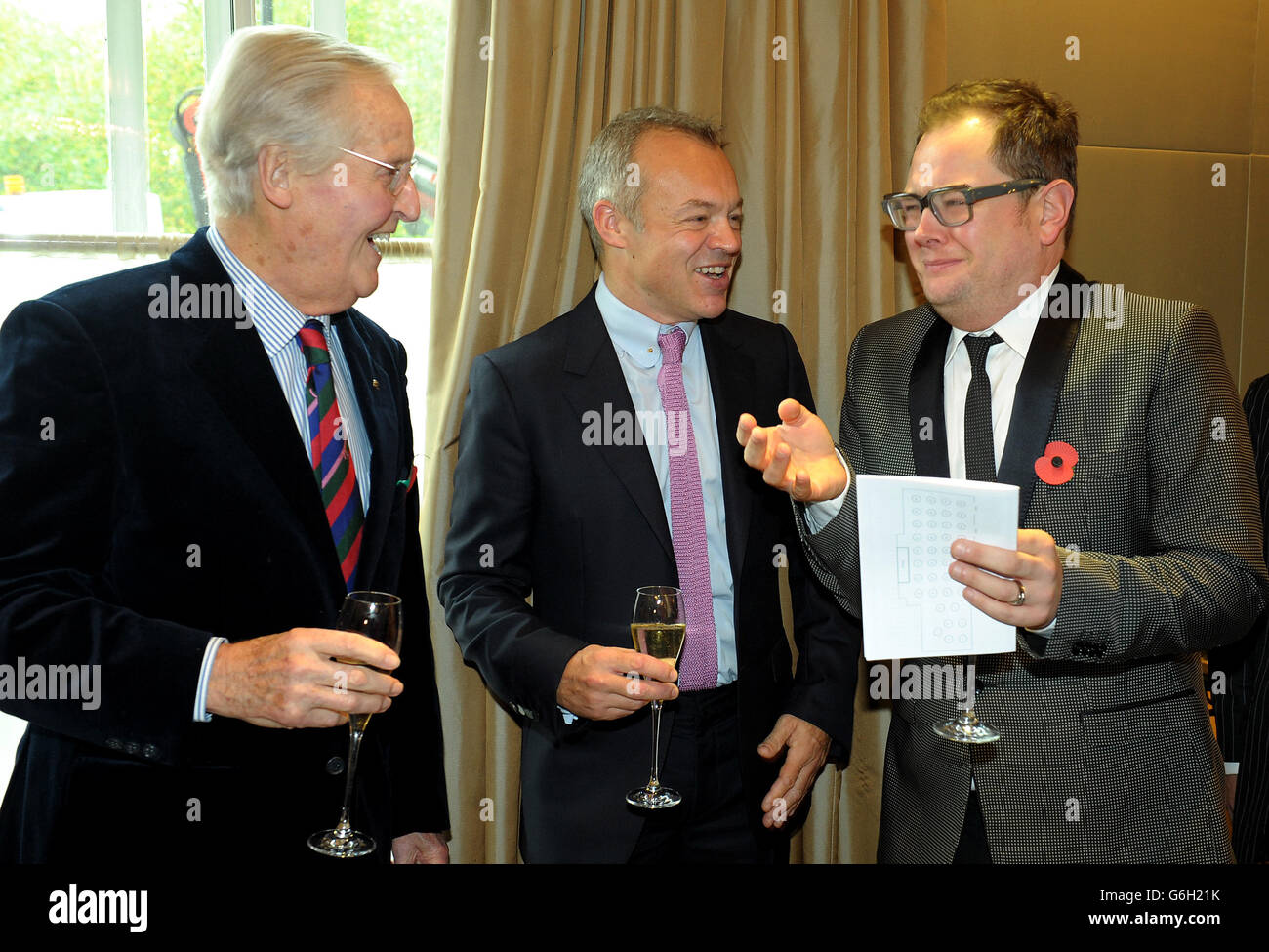Guest of honour Graham Norton speaks with Alan Carr (right) and Nicholas Parsons (left) during a tribute lunch hosted by The Lady Taverners at the Dorchester Hotel, London. Stock Photo