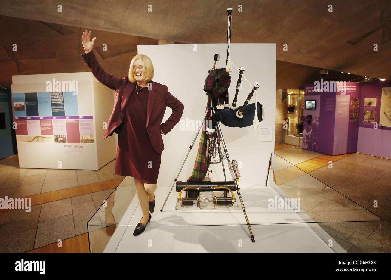 Holyrood Presiding Officer Tricia Marwick with a bagpipe-playing robot during the opening of exhibition Andrew Carnegie: The Legacy That Changed The World, that opened today at the Scottish Parliament in Edinburgh. Stock Photo