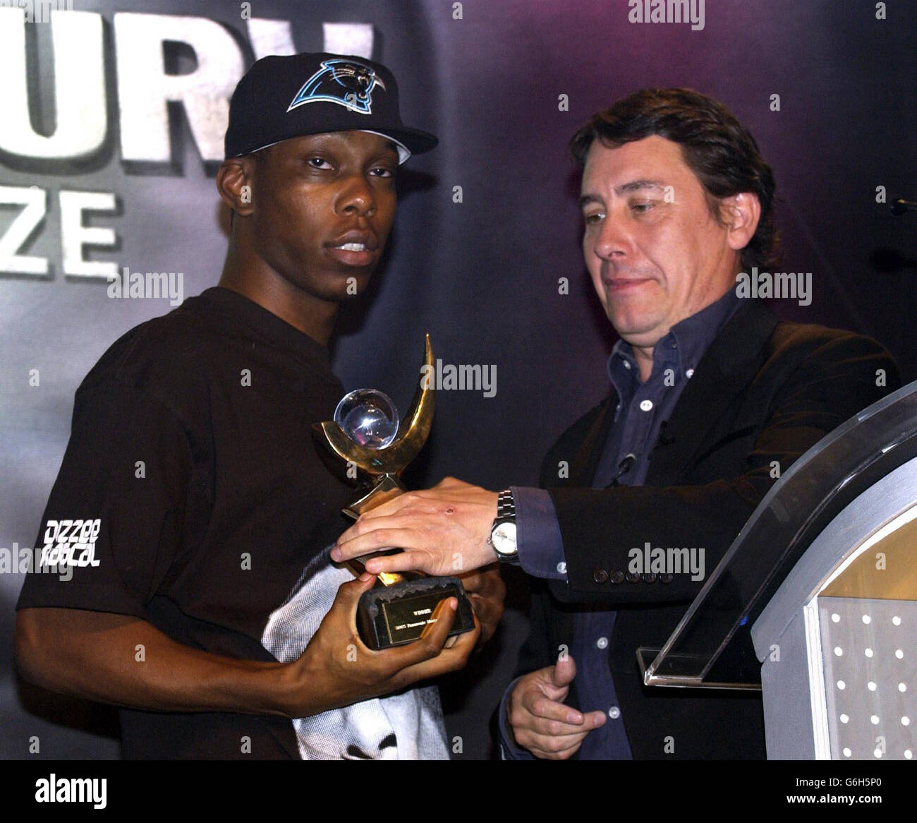 19-year-old Garage star Dizzee Rascal receives the Panasonic Mercury Music Prize for his album 'Boy In Da Corner' from host Jools Holland at the Grosvenor House Hotel in central London. Stock Photo