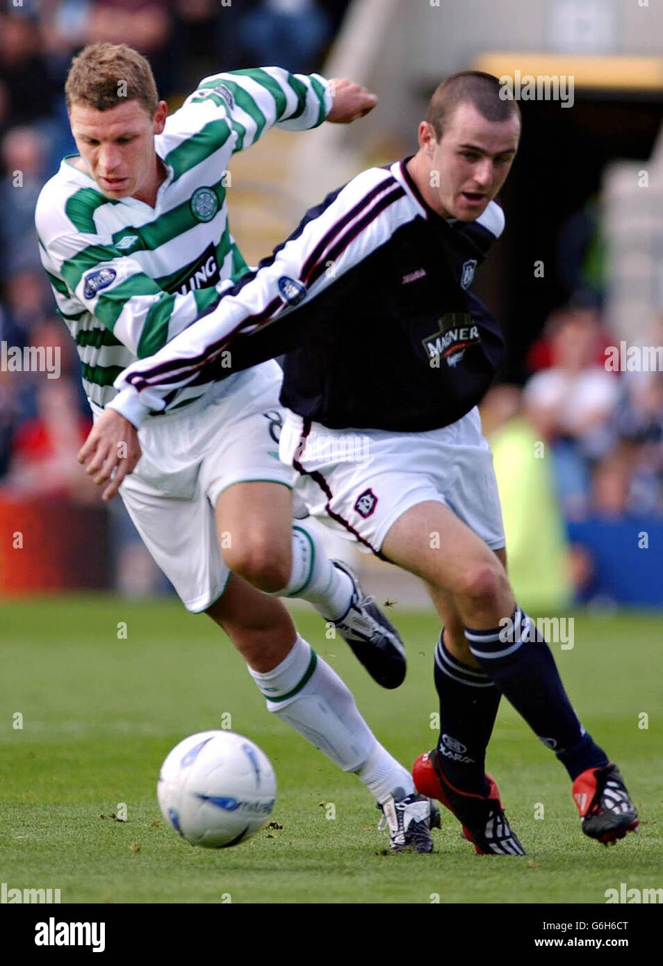 Celtic's Alan Thompson (L) holds off Dundee's Gavin Rae during their ...