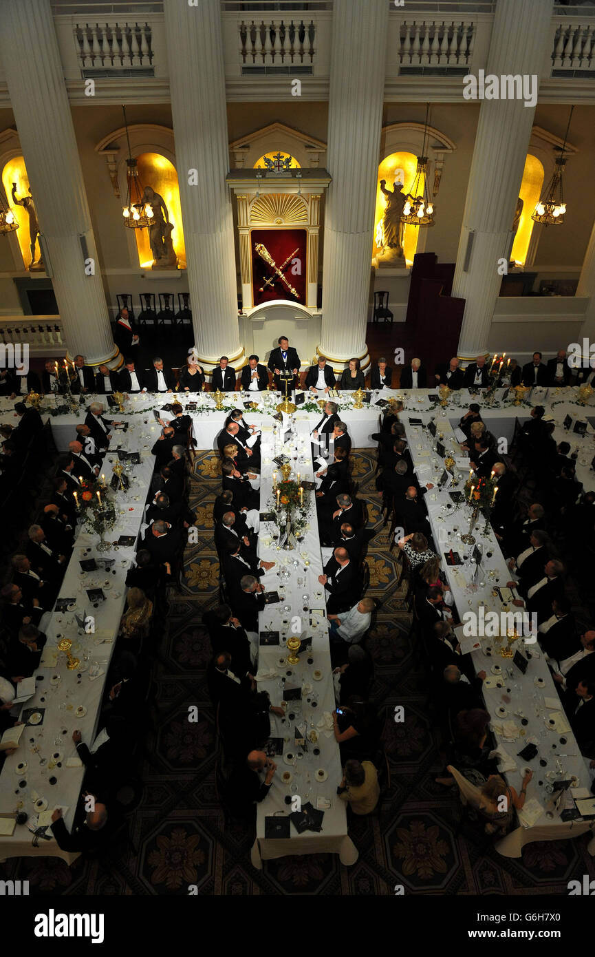 The Lord Mayor Roger Gifford (centre back) delivers his speech as Prudential Regulation Authority chief executive Andrew Bailey (left) and the Financial Conduct Authority chief executive Martin Wheatley (right) listen, during the City Banquet at Mansion House in the City of London. Stock Photo