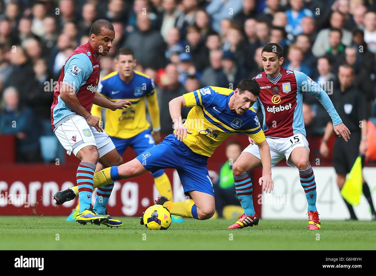Everton's Gareth Barry goes down under a challenge from Aston Villa's Gabriel Agbonlahor (left) Stock Photo