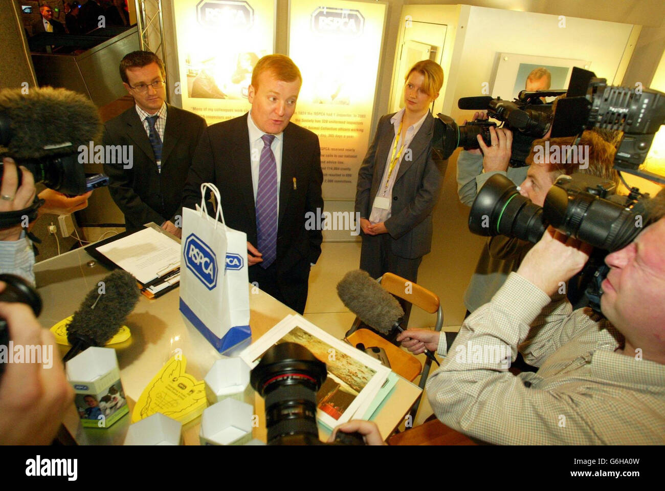 Liberal Democrat leader Charles Kennedy talks to the press on a tour round the exhibition hall, during his party s conference in Brighton. The middle classes should be prepared to pay a little more to create a decent society, Kennedy said today. He conceded that about a third of households would end up paying more tax under his party's proposals to introduce a local income tax. But he said replacing the council tax would benefit those who needed it most, such as the elderly. Stock Photo