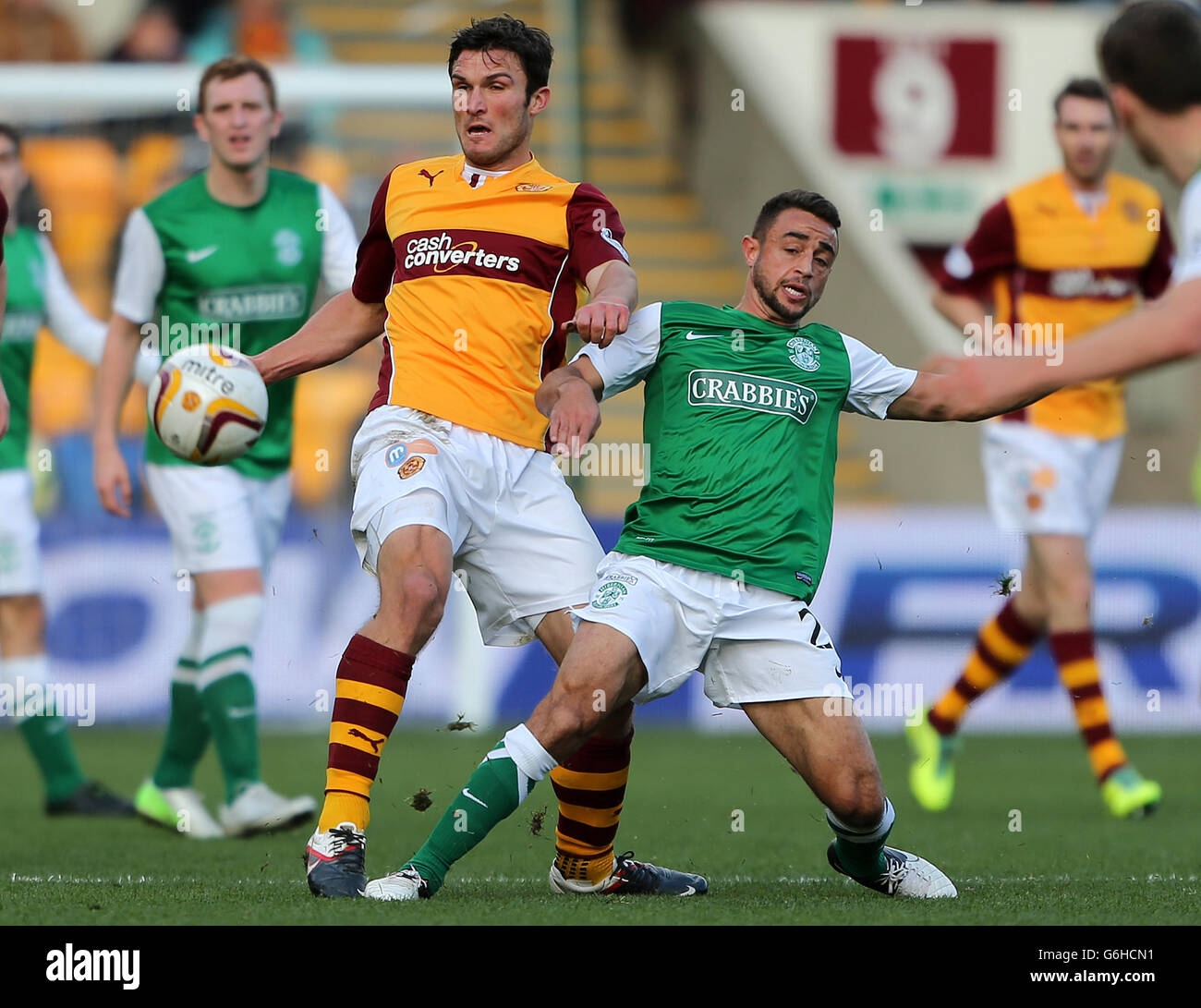 Motherwell's John Sutton challenges Hibernian's Tom Taiwo during the