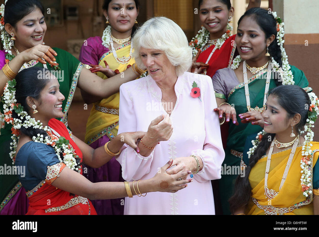 The Duchess of Cornwall is shown some Indian dance moves by girls from Asha Sadan (House of Hope) for children who have been abandoned or abused, in Mumbai, on the fourth day of their official visit to India and Sri Lanka. PRESS ASSOCIATION Photo. Picture date: Saturday November 9, 2013. See PA story ROYAL Tour. Photo credit should read: Chris Jackson/PA Wire Stock Photo