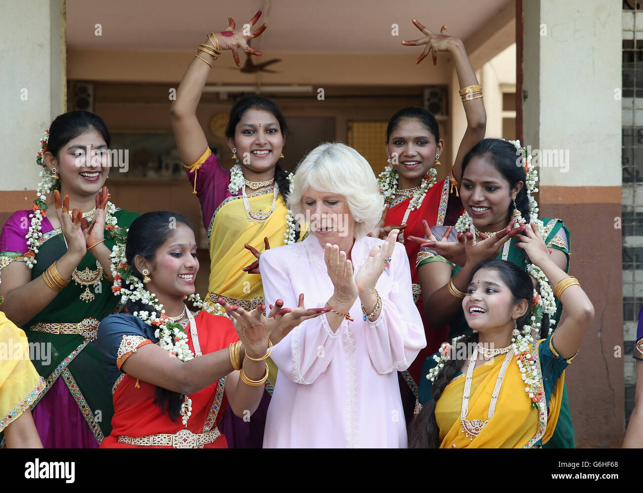 The Duchess of Cornwall is shown some Indian dance moves by girls from Asha Sadan (House of Hope) for children who have been abandoned or abused, in Mumbai, on the fourth day of their official visit to India and Sri Lanka. PRESS ASSOCIATION Photo. Picture date: Saturday November 9, 2013. See PA story ROYAL Tour. Photo credit should read: Chris Jackson/PA Wire Stock Photo