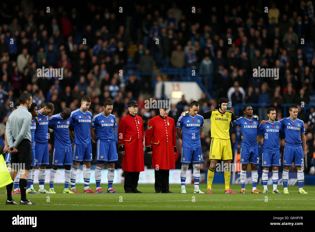 Chelsea players and pensioners observe a minutes silence ahead of Remembrance Sunday during the Barclays Premier League match at Stamford Bridge, London. Stock Photo