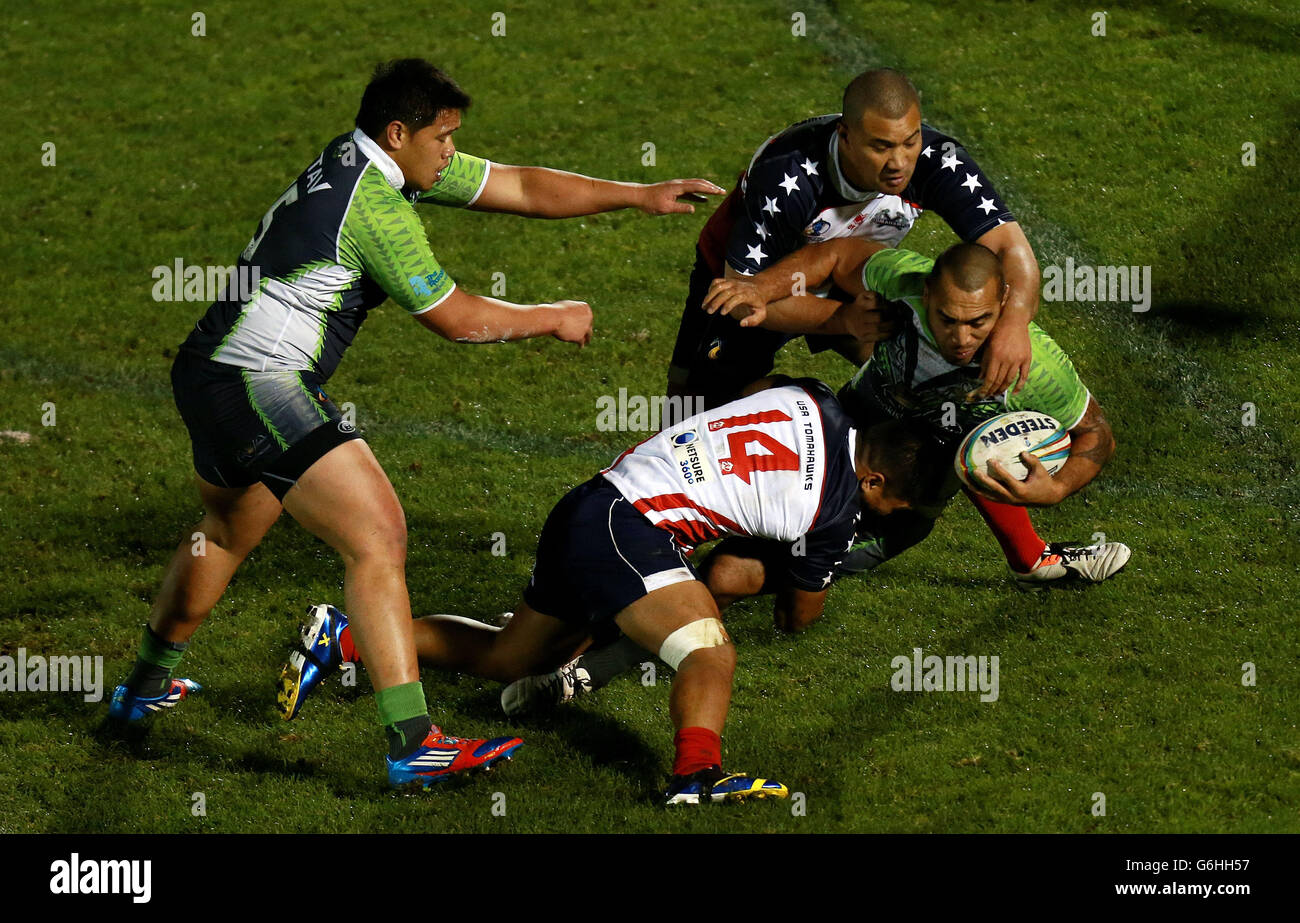 Cook Island's John Zebelon Taia is tackled by USA's Tuisegasega Samoa during the 2013 World Cup match at the Memorial Stadium, Bristol. Stock Photo