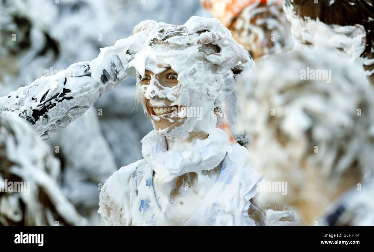 Students at St Andrews University take part in a foam fight in St. Salvator's Quad as part of the Raisin Day celebrations. Stock Photo