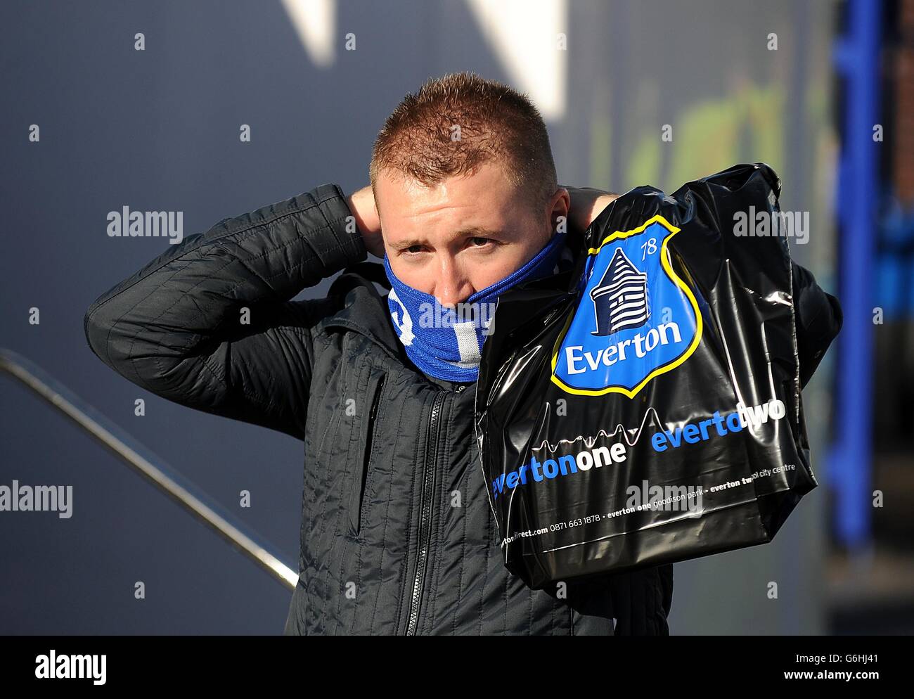 An Everton fan keeps warm outside Goodison Park before kickoff Stock