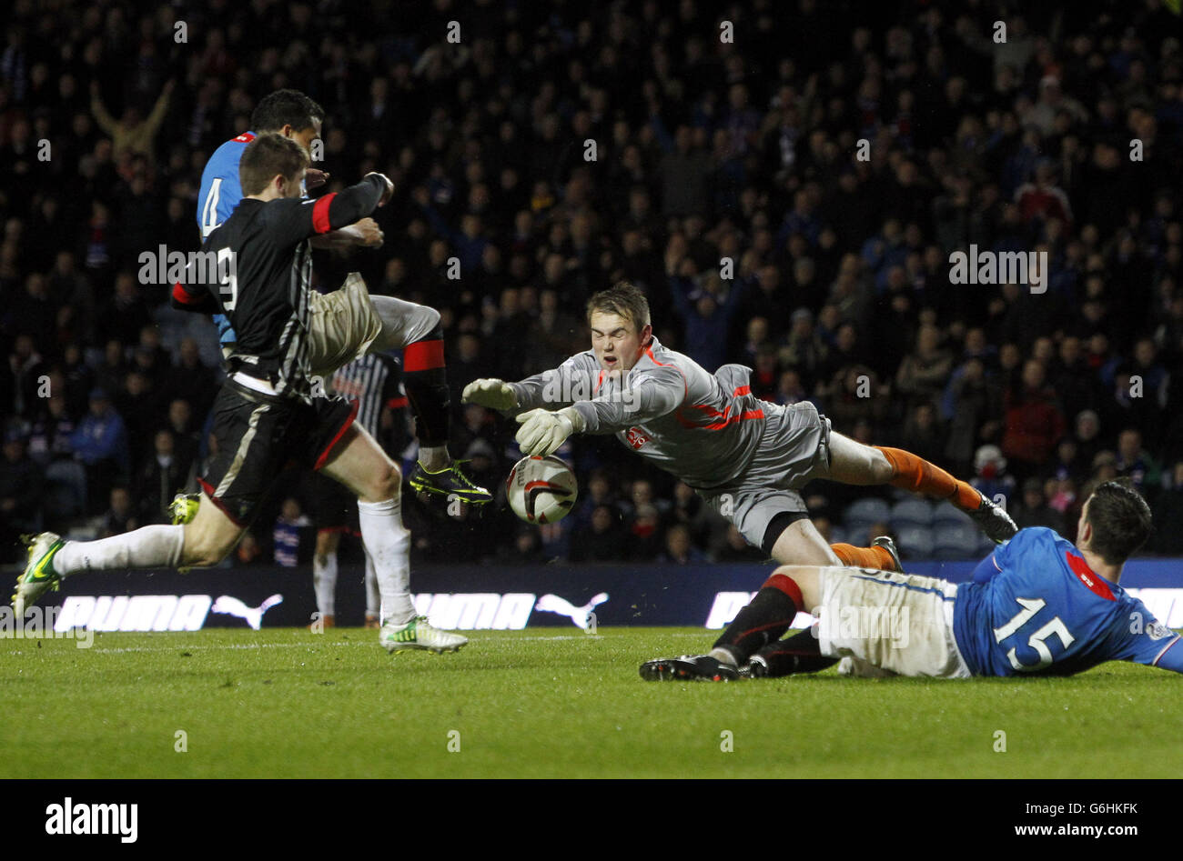 Dunfermline Athletic keeper Ryan Scully beats Rangers' Arnold Peralta to the ball during the Scottish League One match at Ibrox Stadium, Glasgow. Stock Photo