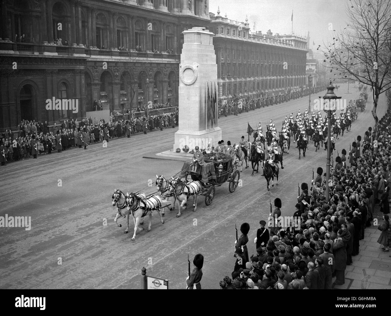 The Irish State coach passes the Cenotaph in Whitehall during the Royal drive to Westminster where the Queen, accompanied by the Duke of Edinburgh, opened Parliament for the first time in her reign. Riding with the Duke in the Irish State coach, the Queen drove in procession from Buckingham Palace to the House of Lords, returning in procession after making the traditional speech from the Throne. Stock Photo