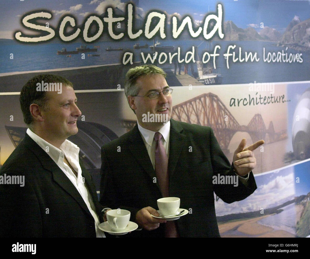 Producer Peter McAleese and culture minister Frank McAveety at Scottish Screen headquarters in Glasgow, following the announcement that Hollywood star George Clooney will start filming a 19 million ($32 million) blockbuster in Scotland early next year. Oscar-winning actor Adrian Brody and newcomer Keira Knightley will star in the thriller about a Gulf War veteran who is accused of a murder he does not remember committing. The Jacket, which is set in North America, will be shot in West Lothian and locations in Glasgow, with filming due to start in January. It is expected to last seven weeks Stock Photo