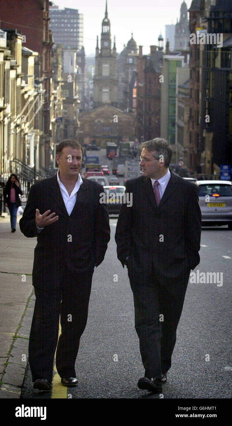 Culture minister (right) Frank McAveety and movie producer Peter McAleese outside the Scottish Screen headquarters in Glasgow, following the announcement that Hollywood star George Clooney will start filming a 19 million ($32 million) blockbuster in Scotland early next year. Oscar-winning actor Adrian Brody and newcomer Keira Knightley will star in the thriller about a Gulf War veteran who is accused of a murder he does not remember committing. The Jacket, which is set in North America, will be shot in West Lothian and locations in Glasgow, with filming due to start in January. It is expected Stock Photo