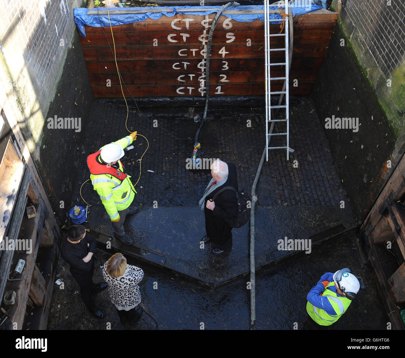 Maintenance workers show guests around during an open event as Camden Lock is drained for maintenance as part of a 45 million pounds sterling national project to maintain the UK's canal system. The drained lock is open to the public this weekend. Stock Photo