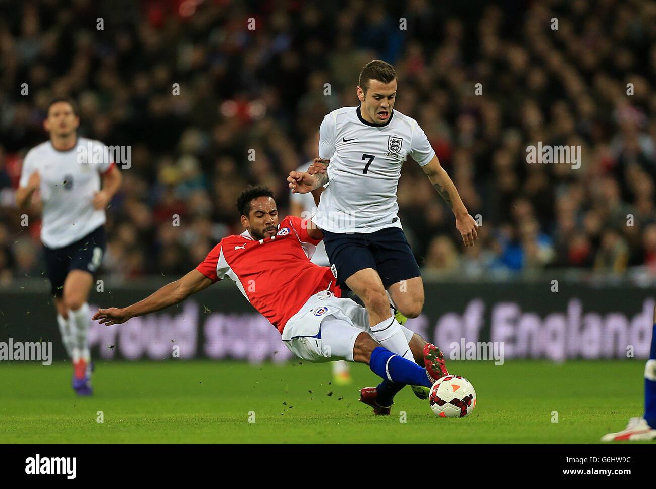 England's Jack Wilshere (right) and Chile's Jean Beausejour battle for the ball Stock Photo