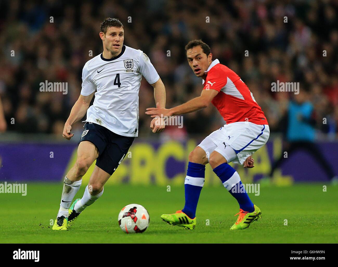 Soccer - International Friendly - England v Chile - Wembley Stadium. Chile's Marcelo Diaz (right) and England's James Milner battle for the ball Stock Photo