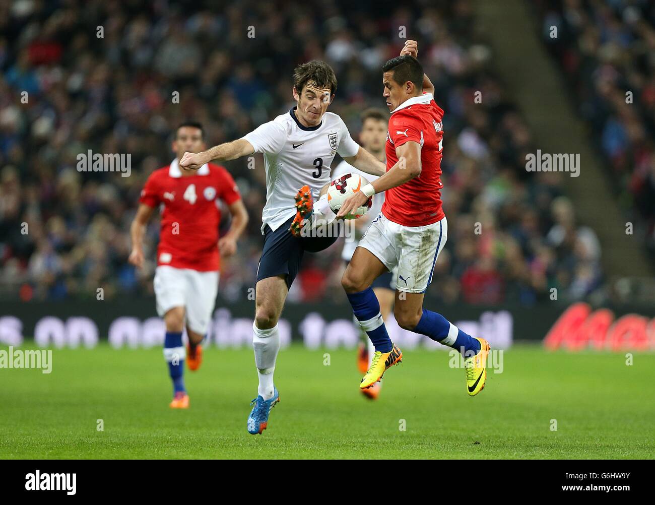 Chile's Sanchez Alexis (right) and England's Leighton Baines battle for the ball Stock Photo