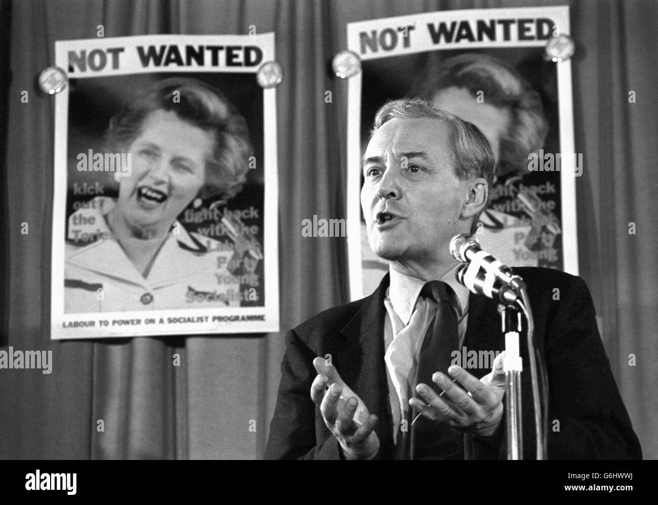Anthony Wedgwood Benn gives a speech to the Greater London Labour Party Young Socialists at Rotherhithe Civic Centre. In the background is a poster with Margaret Thatcher on under the headline 'Not Wanted'. Stock Photo