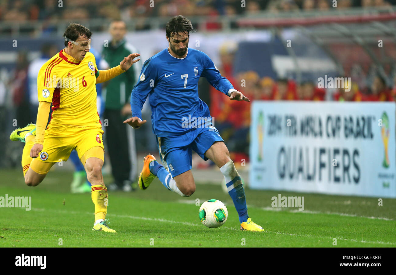 Soccer - FIFA World Cup Qualifying - Play off - Second Leg - Romania v Greece - National Arena. Romania's Vlad lulian Chiriches and Greece's Georgios Samaras compete for the ball Stock Photo