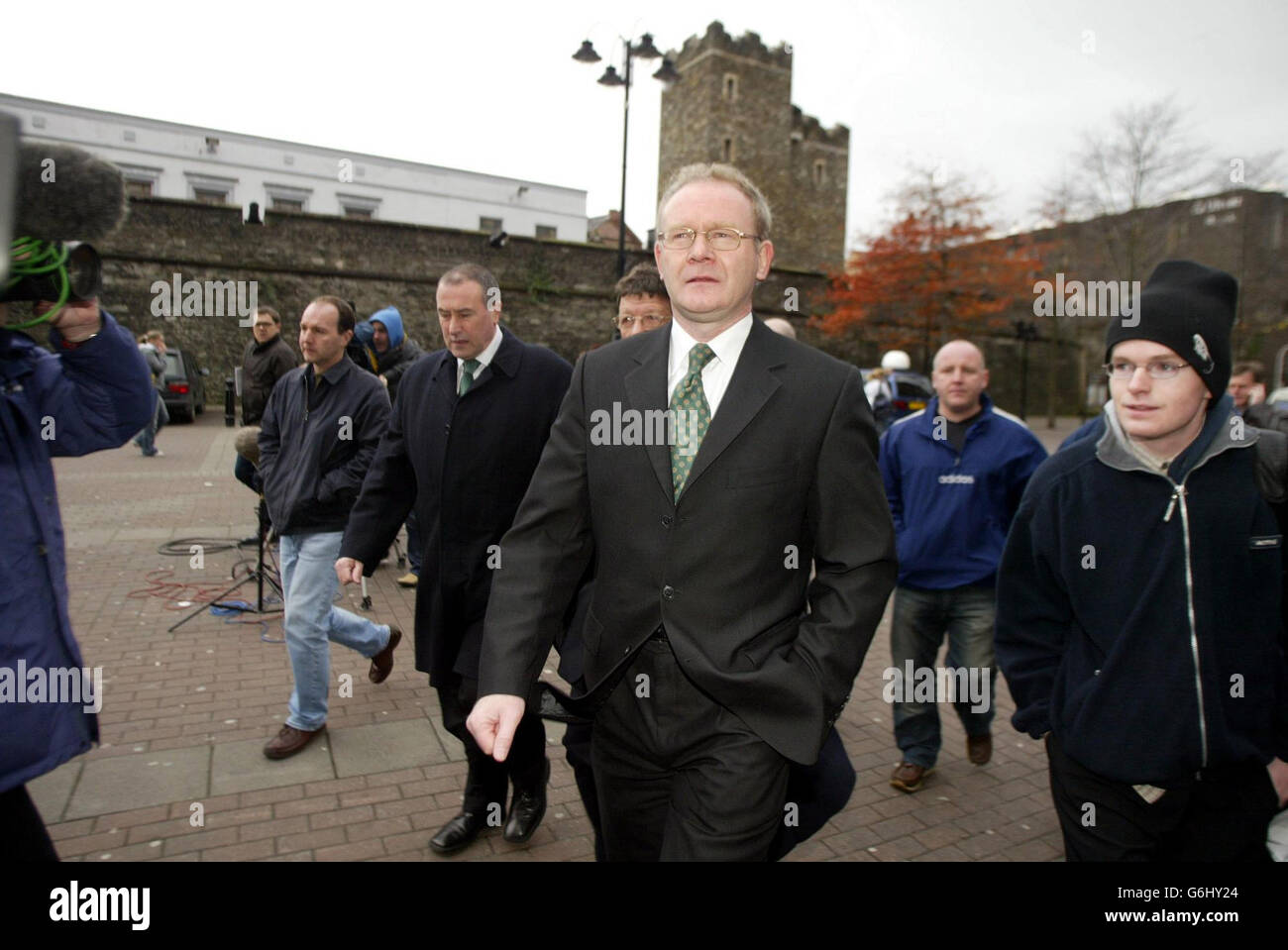 Sinn Fein's Martin McGuinness (centre) arriving at the Guildhall in Londonderry with colleagues from Sinn Fein to give evidence to the Bloody Sunday inquiry. Mr McGuinness, who has admitted being second in command of the IRA on Bloody Sunday, said he was at the Saville Inquiry to tell the truth about the 1972 killings by the British army in the city. Stock Photo