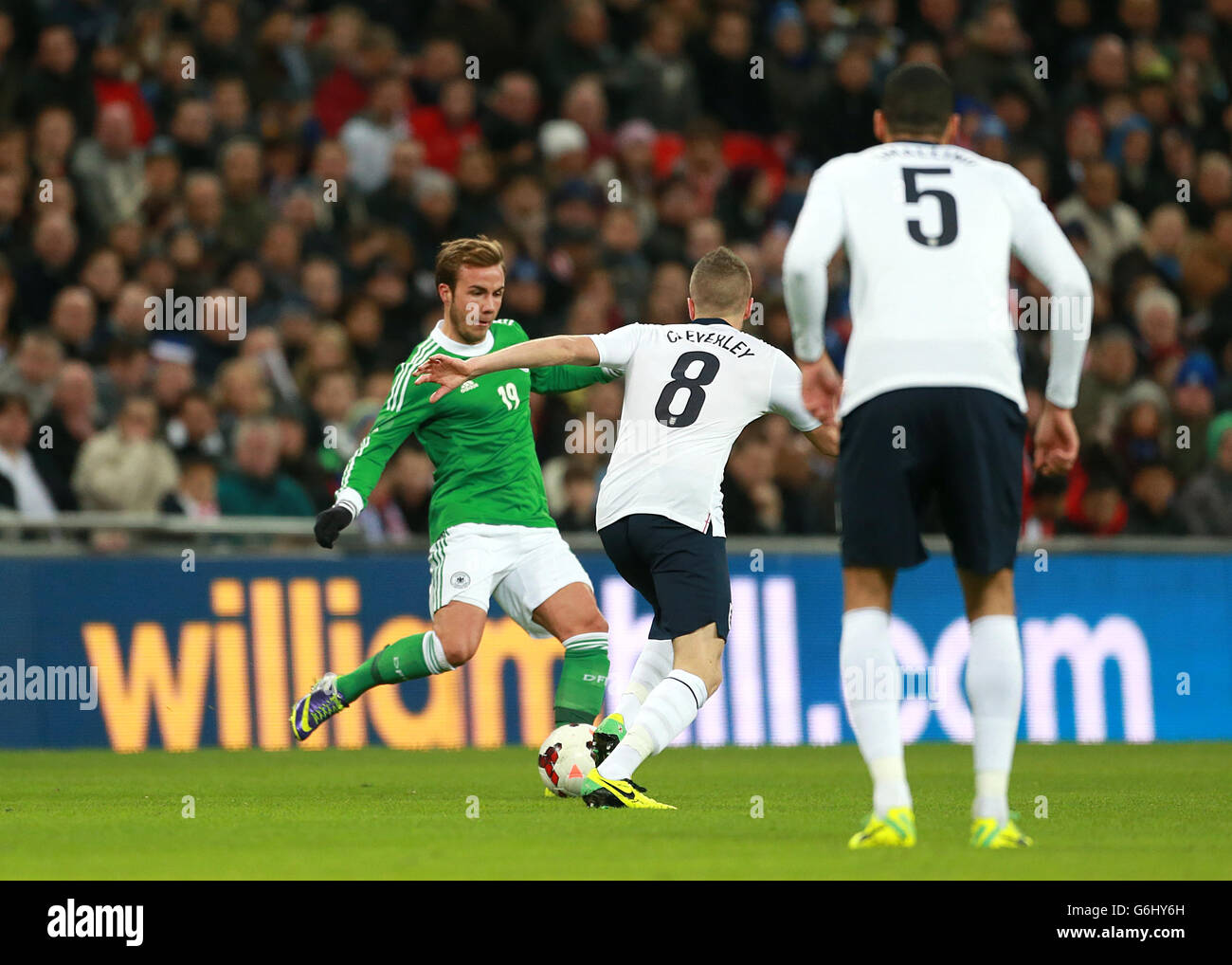 Soccer - International Friendly - England v Germany - Wembley Stadium. Germany's Mario Gotze (left) and England's Tom Cleverley battle for the ball Stock Photo