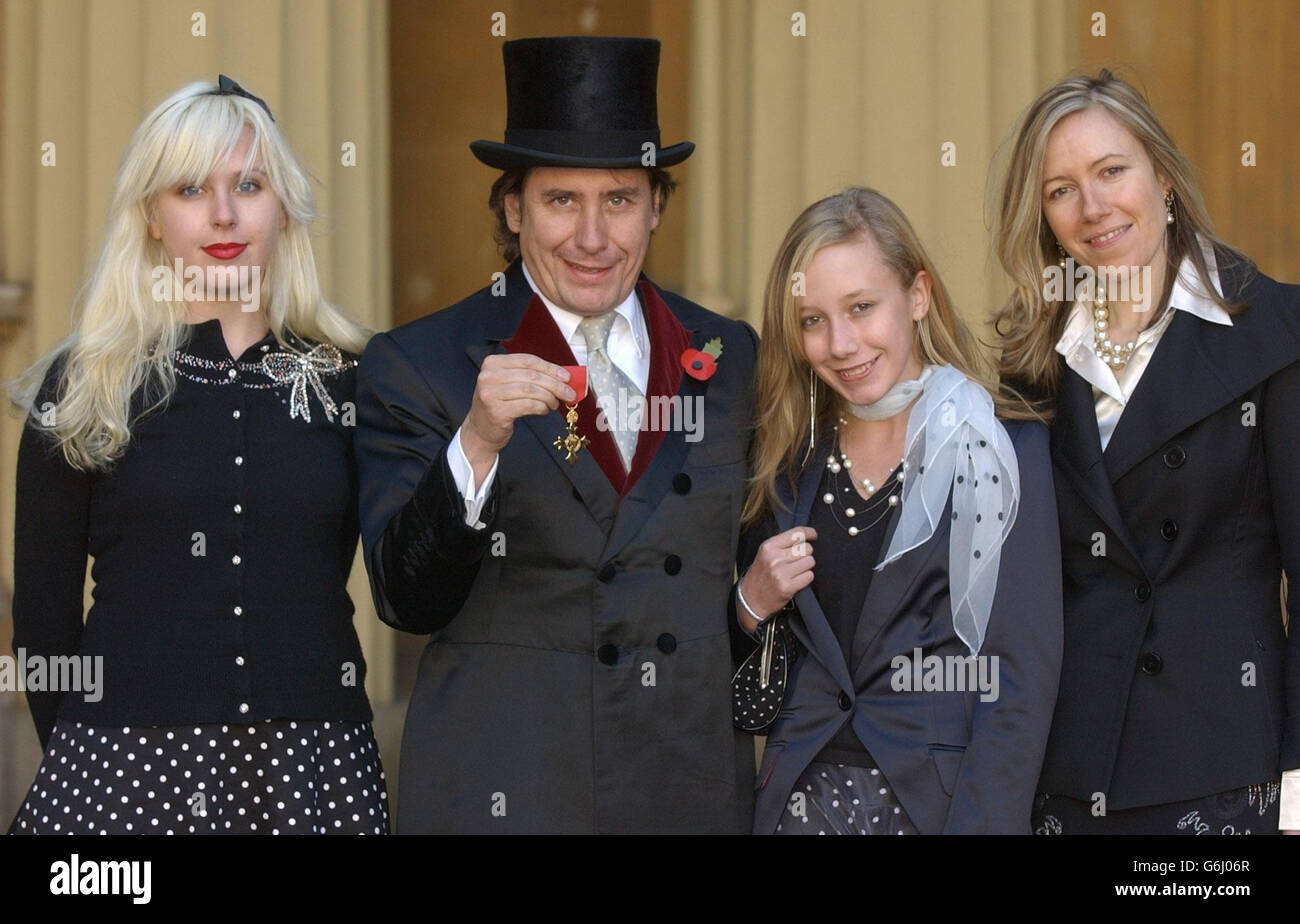 Musician Jools Holland with his daughters (l-r) Rosie and Mabel and wife Christobel at Buckingham Palace, after being awarded with an an OBE by Britain's Queen Elizabeth II. Holland, 45, said recently: 'I am tremendously honoured to receive this award and proud that the art of boogie-ing has been officially recognised.' Stock Photo