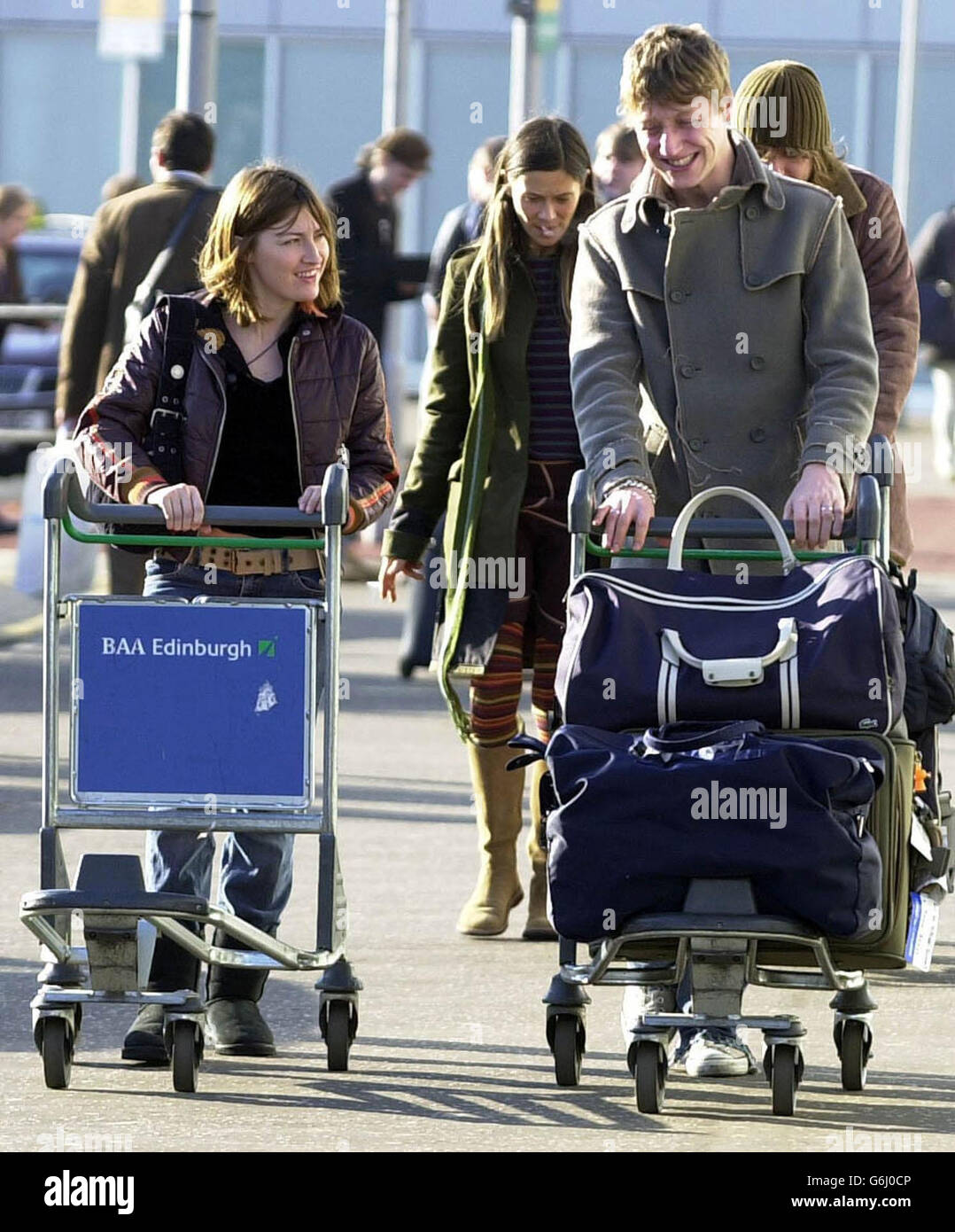 Travis band member Dougie Payne and wife actress Kelly MacDonald at Edinburgh Airport, after appearing at the MTV Europe Music Awards in Edinburgh last night. Stock Photo