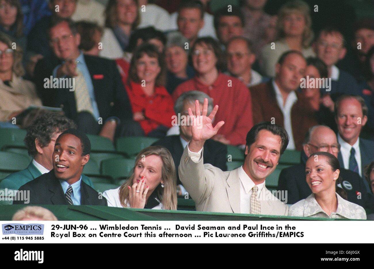 Tennis-Wimbledon 96. David Seaman with girlfriend Debbie (right) and Paul Ince with wife Claire, in the Royal Box on Centre Court Stock Photo