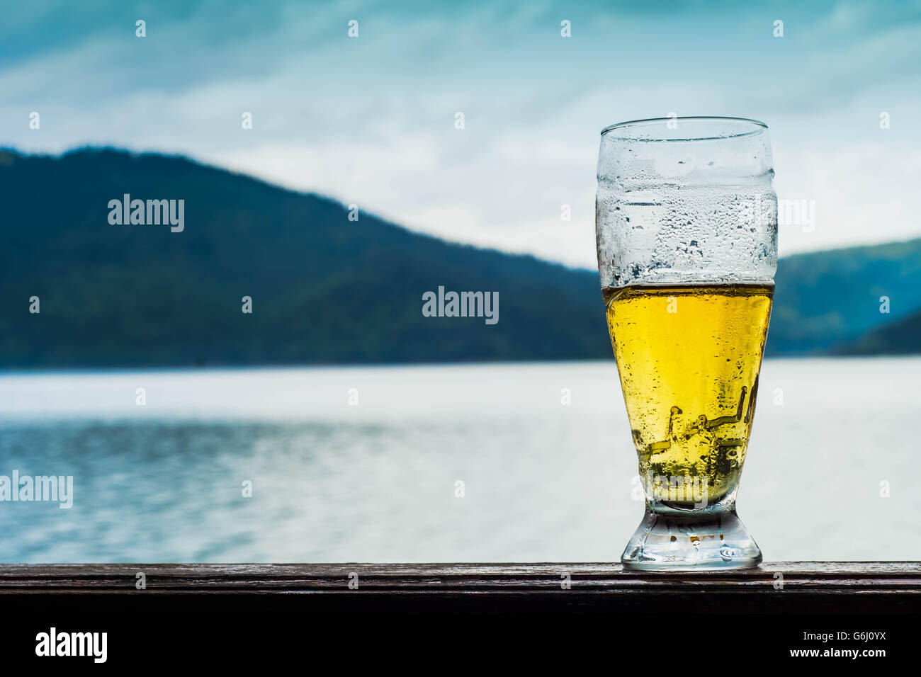 Glass of beer on the mountain lake Stock Photo