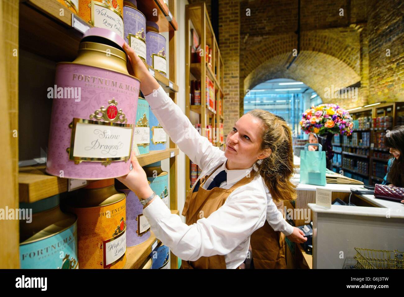 Staff prepare tea in the first new Fortnum and Mason store for more than 300 years, at St Pancras International Station, central London. Stock Photo
