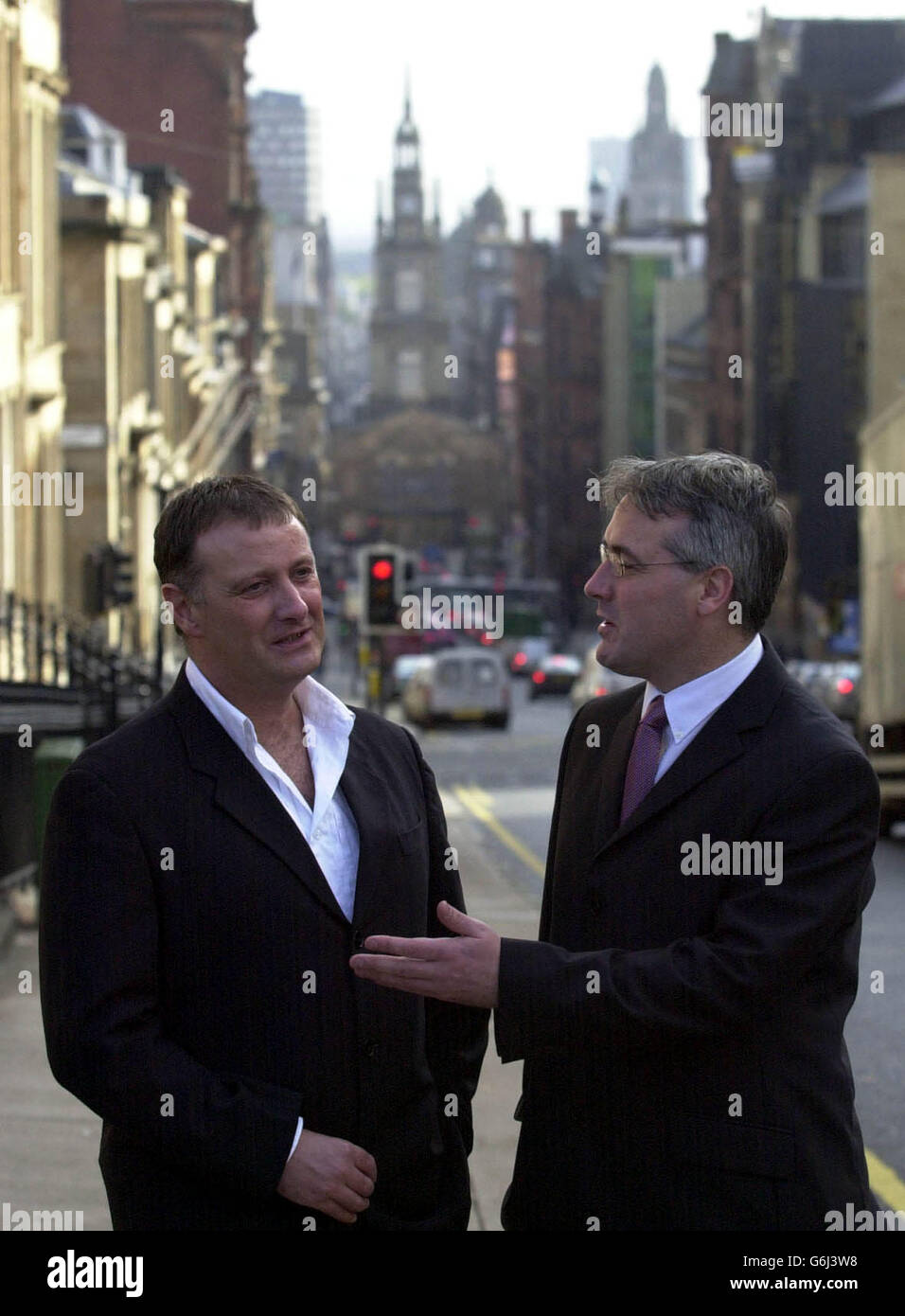 Peter McAleese and Frank McAveety discuss the announcment outside the Scottish Screen headquarters in Glasgow that a Thirty Two Million dollar Hollywood movie is set to be shot in Scotland.The film entitled 'The Jacket' will be produced by George Clooney and Steven Soderbergh's Section Eight production comapny. The announcment was made by Frank McAveety Msp, Minister for Culture, along with UK producer of the film Peter McAleese . Stock Photo