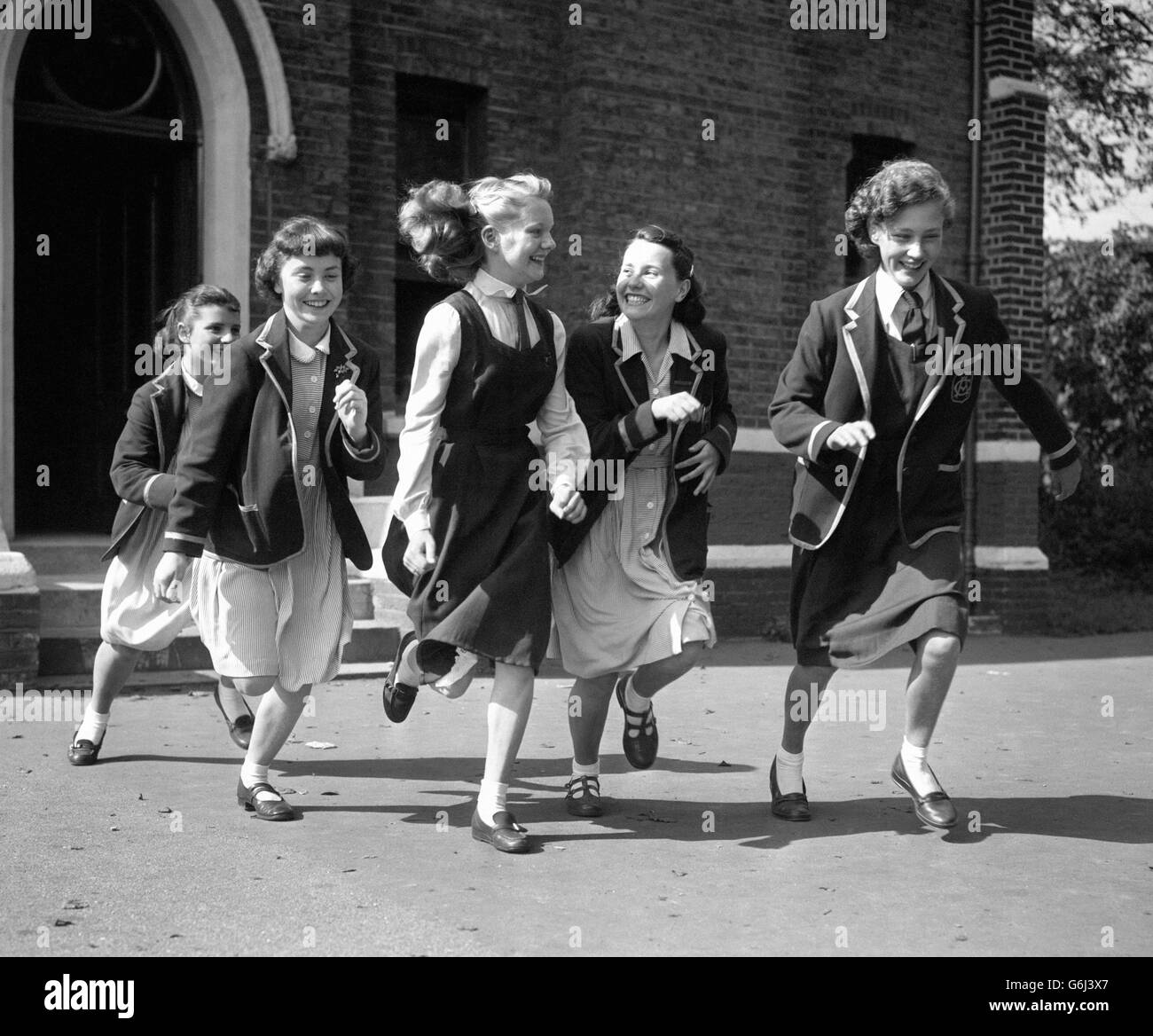 Lessons are over for the day and 14-year-old Carole Oliver (centre in gym dress) hurries from school at Hammersmith, London, with some of her friends. Carole is to be seen as the new Margaret in the seventh series of The Appleyards. Stock Photo