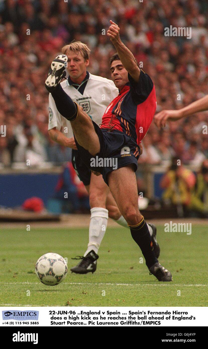 22-JUN-96 ..England v Spain, Spain's Fernando Hierro does a high kick as he reaches the ball ahead of England's Stuart Pearce Stock Photo