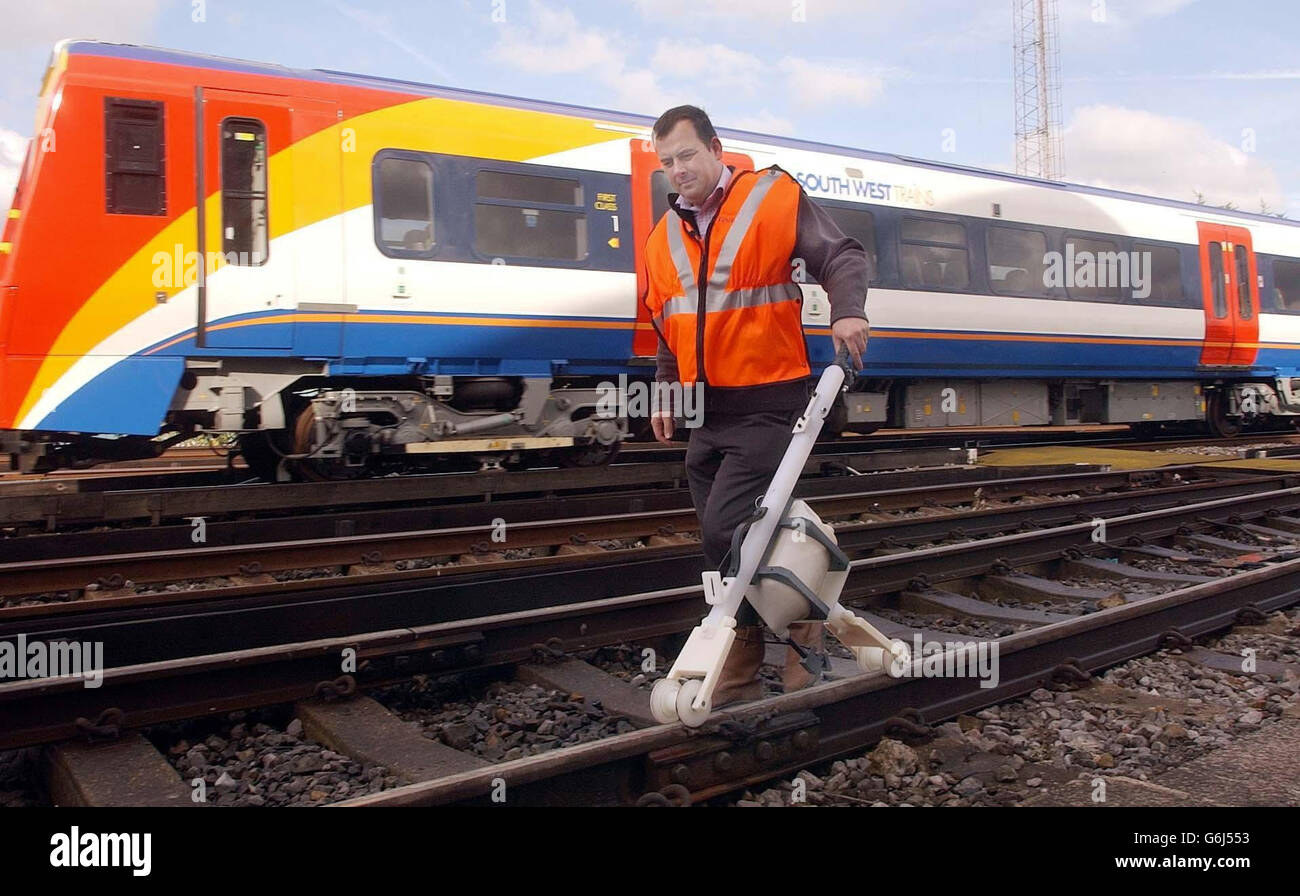 A hand operated sand-to-track dispenser is used to help solve the problem of train delays due to leaves on the line, at Wimbledon train depot. The traditional method is just one of many ways in which the annual disruption to the rail network is being tackled by Network rail. Stock Photo