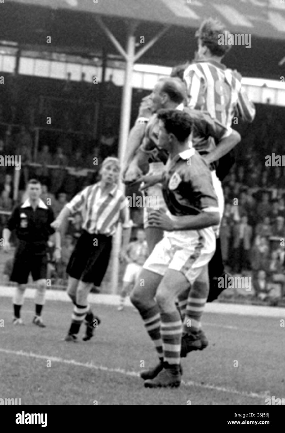 Battle of the heads in the Third Division (South) match between Brentford and Millwall at Griffin Park, Brentford. From camera are Millwall centre-half Hurley; Millwall right-half Short; and (in stripes) Taylor, Brentford centre-forward. Stock Photo