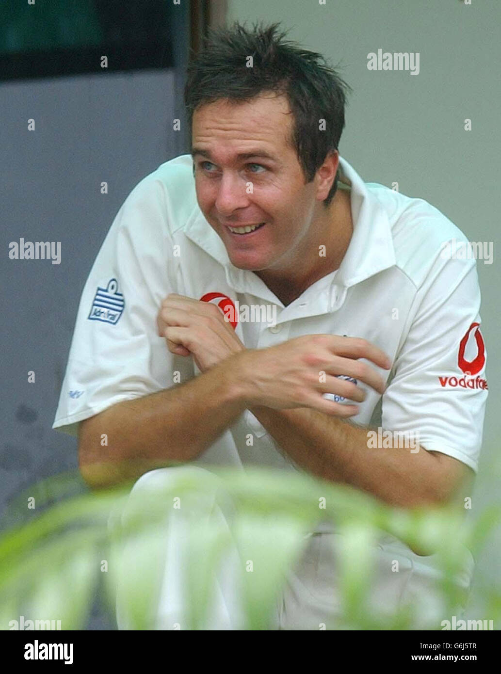 England Captain Michael Vaughan takes cover in the dressing room at the Bangabandhu Stadium in Dhaka, after play in the inaugural Test between England and Bangladesh was halted after less than 20 minutes by torrential rain. Bangladesh had faced only four overs after winning the toss and deciding to bat and had reached one without loss when the storms broke over the ground and sent the players scurrying for the dressing rooms. Stock Photo