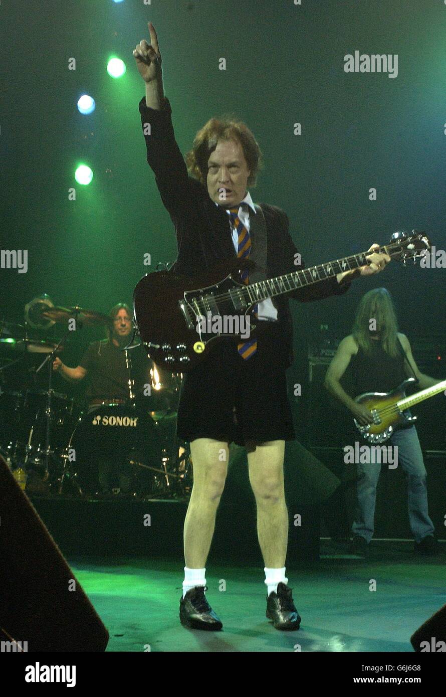 Australian heavymetal band AC/DC's lead guitarist Angus Young performing live in concert at the Carling Hammersmith Apollo in west London. Stock Photo