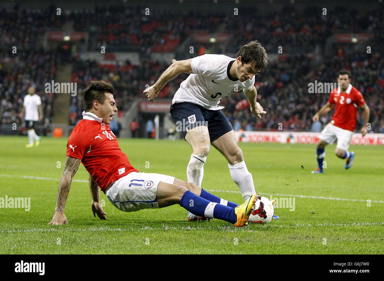 Chile's Eduardo Vargas and England's Leighton Baines (right) battle for the ball Stock Photo