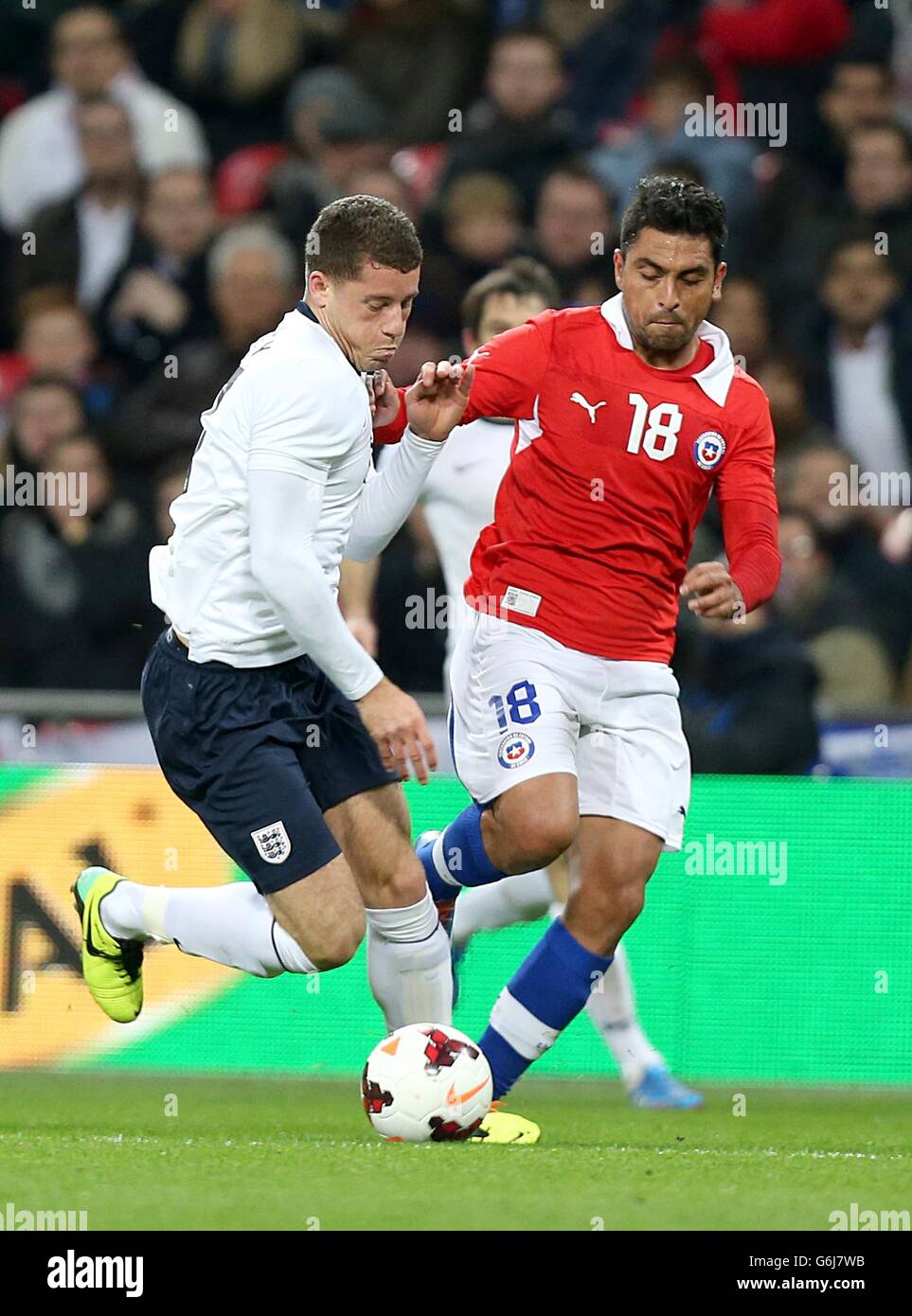Soccer - International Friendly - England v Chile - Wembley Stadium. Chile's Gonzalo Jara and England's Ross Barkley (left) battle for the ball Stock Photo