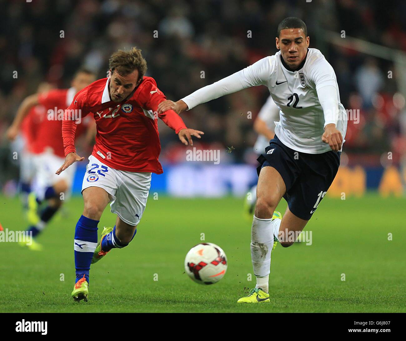 England's Chris Smalling (right) and Chile's Jose Pedro Fuenzalida battle for the ball Stock Photo